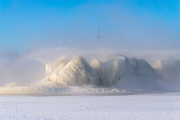 A scenic view of the frozen fountains to cool the thermal power station on a blue sky background