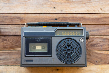 older audio cassette tape old generation on background wooden