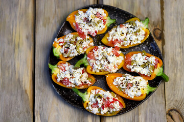 Yellow bell peppers stuffed with ricotta and olives. Healthy snack. Snack diet. Autumn cuisine. Stuffed paprika pepper. Keto diet recipe.