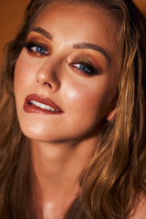 Obraz premium Portrait of a beautiful girl model with makeup. An attractive women of European appearance with blue eyes. Model with beautiful evening make-up