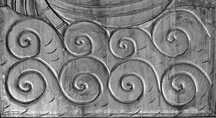 Wood carving detail of line pattern on black and dark background, wooden door, with fish texture carving, vintage decoration.