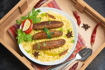 Seekh Kebab Biryani , indian chicken tikka shish kofte kebabs. Delicious homemade Indian Vegetable Kebab Platter basmati rice mayonnaise coriander leaf.  grilled meat skewers, Turkish and Arabic food.
