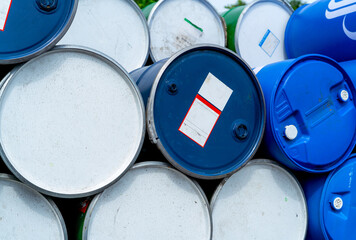 Stack of old chemical barrels. Blue oil drum. Steel and plastic oil tank. Toxic waste warehouse....