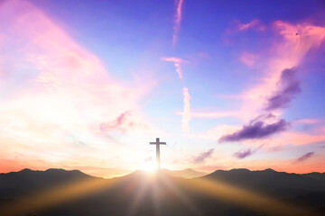 Christian cross concept: Silhouette cross on  mountain sunset background