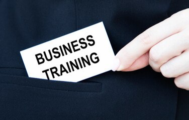 The girl will put in her pocket a business card with the text BUSINESS TRAINING.