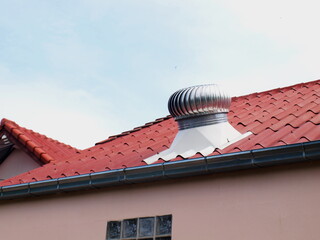 Roof ventilation on the roof. Ball spinning serves to ventilate the house or factory. On a dim blue...