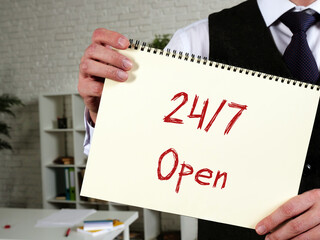 Business concept about 24/7 Open with inscription on the piece of paper.