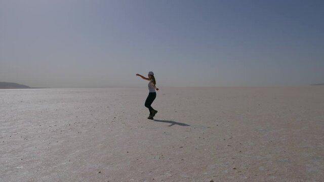 girl running towards camera on salt lake in Turkey, Tuz Gulu, tourism in Turkey