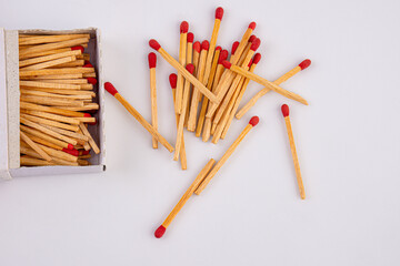 Empty paper matchbox with wooden matches on it