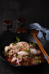 Yentafo in a black bowl. Dark tone picture.