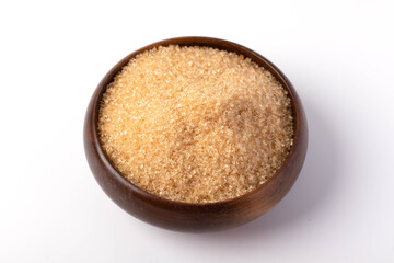 Brown sugar in a wooden cup on a white background