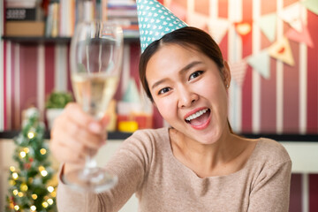 POV Asian woman holding wine glass to celebrate a party via video call conference, new normal for birthday Christmas and new year party at home