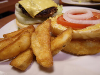 Close up shot of french fries with hamburger
