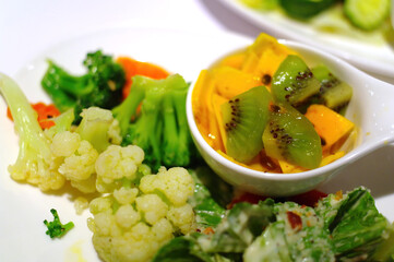 Close up shot of a vegetable salad and fruits