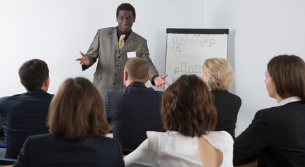 Fototapeta premium Male speaker giving talk on corporate business meeting in meeting room