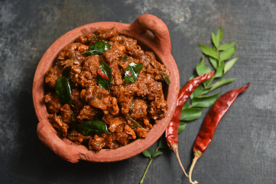 Traditional homemade Mutton curry from Asian cuisine.   Chukhandar gosht. Spicy delicious meat beef curry.  Bowl of tasty mutton roast Indian spices.  side dish of Ghee rice, Appam, Parotta, Puttu