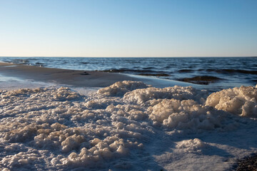 Natural seafoam after storm on the sea. Sea landscape.