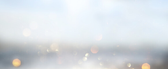 glitter vintage lights background. silver, gold and white. de-focused