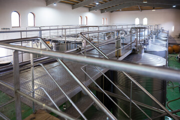 Interior of modern winery with stainless steel tanks for wine fermentation