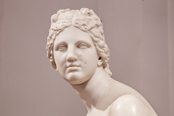 Ancient white marble sculpture head of young woman. Statue of sensual renaissance art era naked...