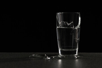broken glass of water from which water flows out