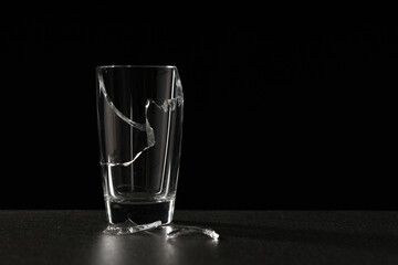broken empty glass on a ceramic surface on a dark background