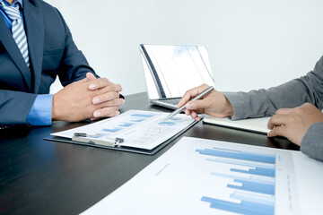 Two business leaders talk about charts, financial graphs showing results are analyzing and calculating planning strategies, business success building processes