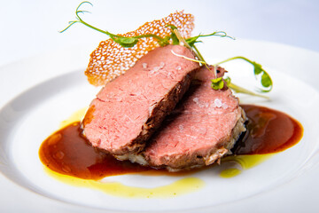 Beautifully baked steak meat served on a white plate