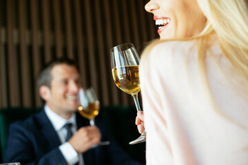 Beautiful businesswoman drinking wine. Businesswoman enjoying in the restaurant.