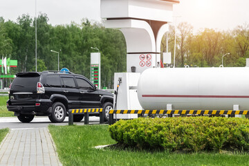 Liquid propane gas station. Black modern SUV car refueling tank with alternative power natural...