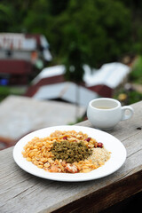 Burmese Tea Leaf Salad or Lahpet before mixed in white compartment plate.