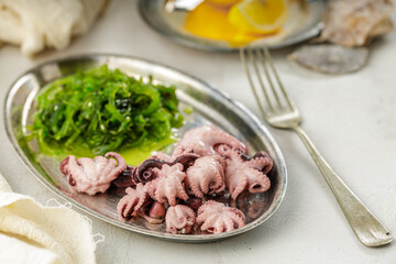 Traditional asian food. Delicious boiled octopus with fresh wakame salad.