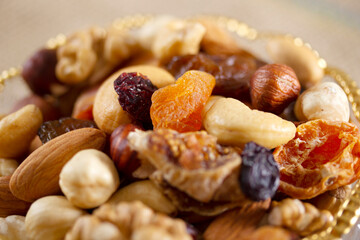 Mixed nuts in a glass plate. Healthy and natural nutrition .Cashew, Almond,, Hazelnut,, Fig,, Walnut,, Apricot,, Raisin,, Blueberry.
