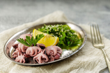 Traditional asian food. Delicious boiled octopus with fresh wakame salad.