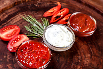 Rack of lamb roasted over charcoal with vegetables and spices on a wooden board. European cuisine.