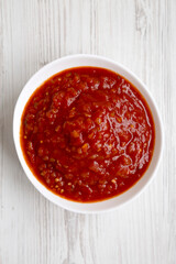 Homemade Tomato Salsa on a white wooden background, top view. Flat lay, overhead, from above.