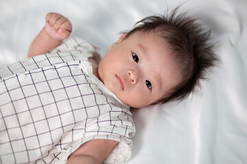 Portraiture image of Three month old Asian Cute little baby boy lsolated on white background