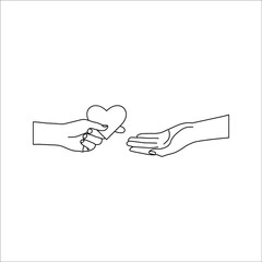 hand giving a heart to another one’s hand. Concept about love, care, sharing, donation, human kindness.