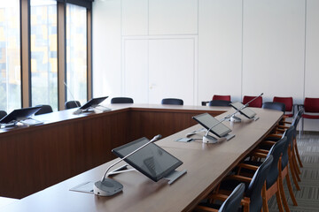 Image of empty board room with computers on the table in modern office building