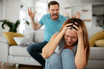 Fototapeta premium Violence in family. Husband beating his wife.