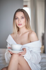 Obraz na płótnie Canvas woman drinking morning coffee in her apartment