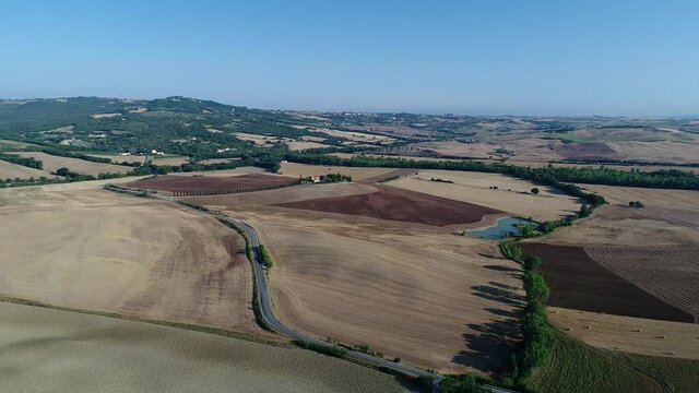 Aerial view of the sunrise in the valley of the orc, the sun just arose, the countryside in Tuscany