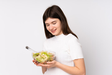 Young Ukrainian teenager girl holding a salad over isolated white background
