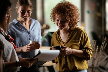 Colleagues in office talking and having fun. Friends working together..