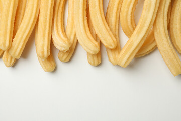 Tasty sweet churros on white background, top view