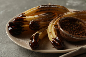 Concept of sweet lunch with churros on gray table