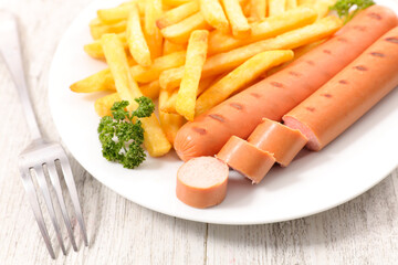 sausage and french fries in plate