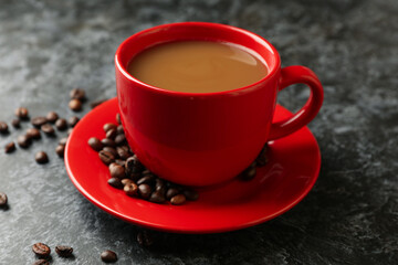 Red cup of coffee on black smoky background