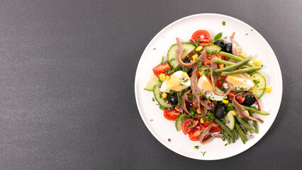 vegetable salad with egg, cucumber, tomato and anchovy