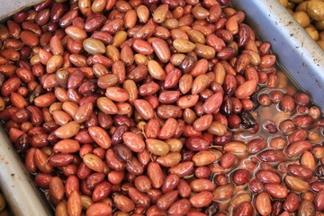 Stall with Kalamata or Kalamon olives at street market in Athens, Greece.